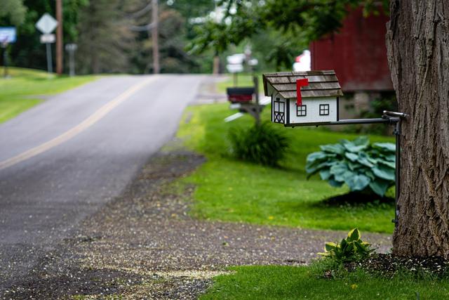 a-traditional-american-wooden-mailbox-that-looks-like-a-cottage-on-the-side-of-a-village-road-mailbox_t20_ynrOg9.jpg