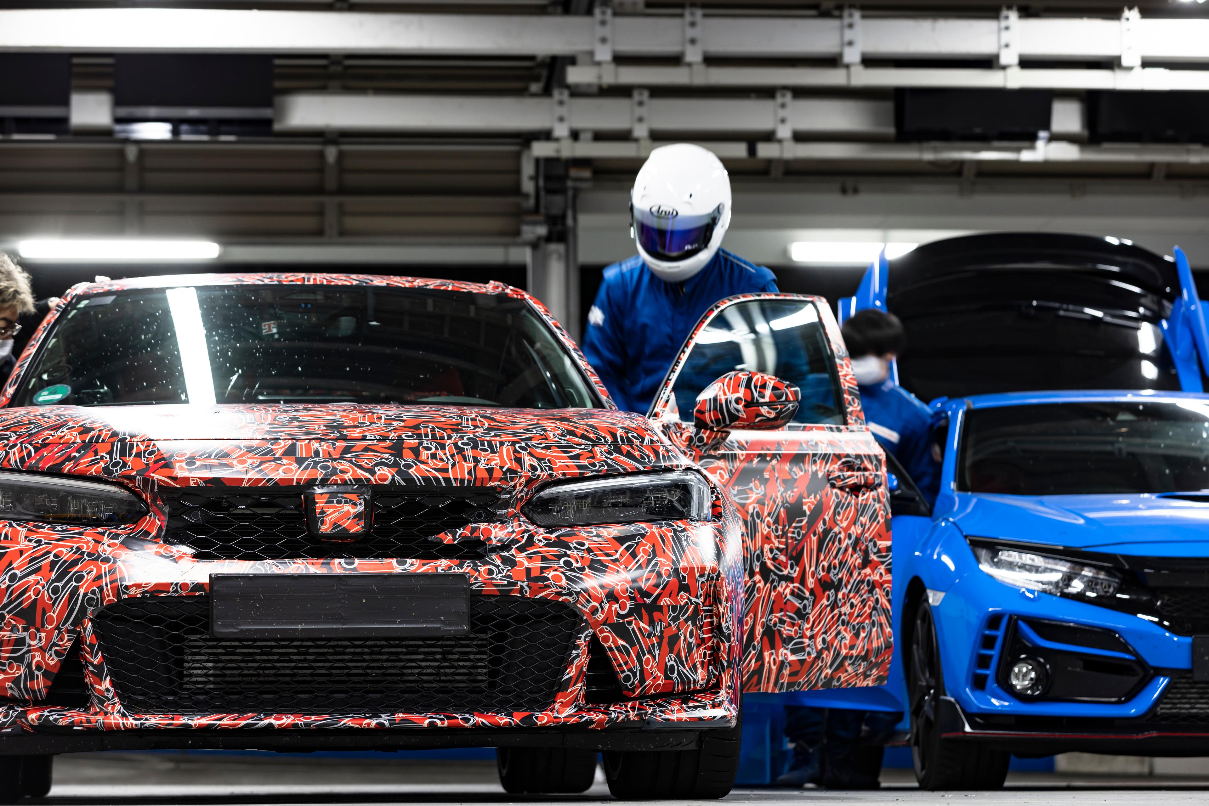 Image of the colorful and uniquely painted Civic Type R from Tokyo Salon with a race car driver stepping into the driver's seat wearing a white helmet and blue suit.