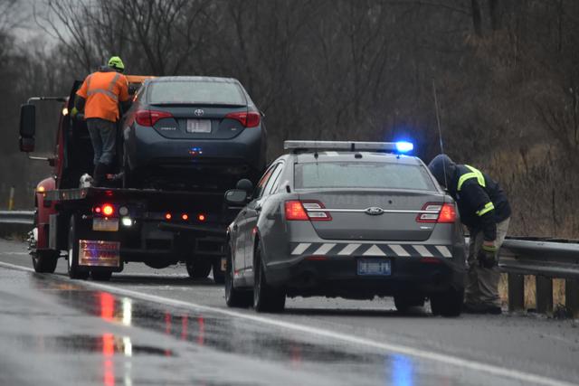 car-accident-on-a-slippery-interstate-during-sleet-freezing-rain-police-car-on-the-scene-helping-with_t20_XxLV9r.jpg