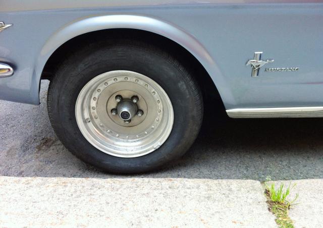 great-and-cool-design-of-that-blue-grey-loved-mustang-parked-car-sunny-wheel-closeup-copy-space_t20_e3b9po.jpg