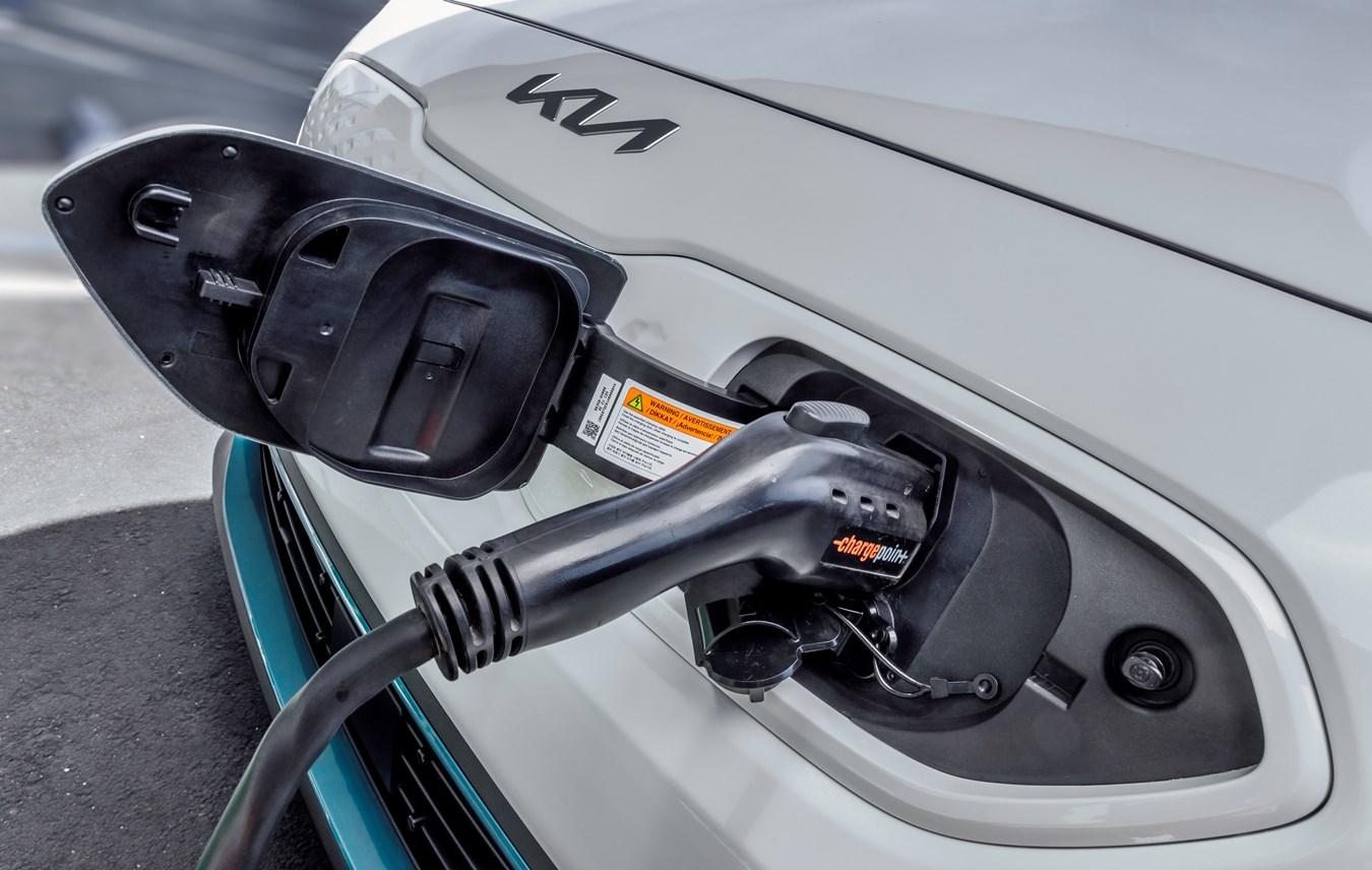 A 2022 Kia Niro EV plugged into a charging station.