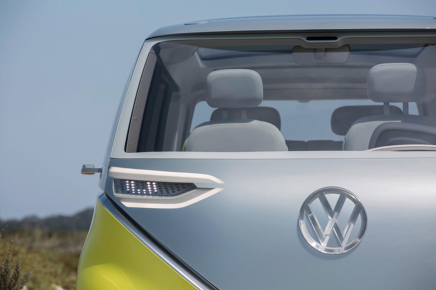 A closeup of the front of a gray and yellow Volkswagen ID. Buzz microbus.