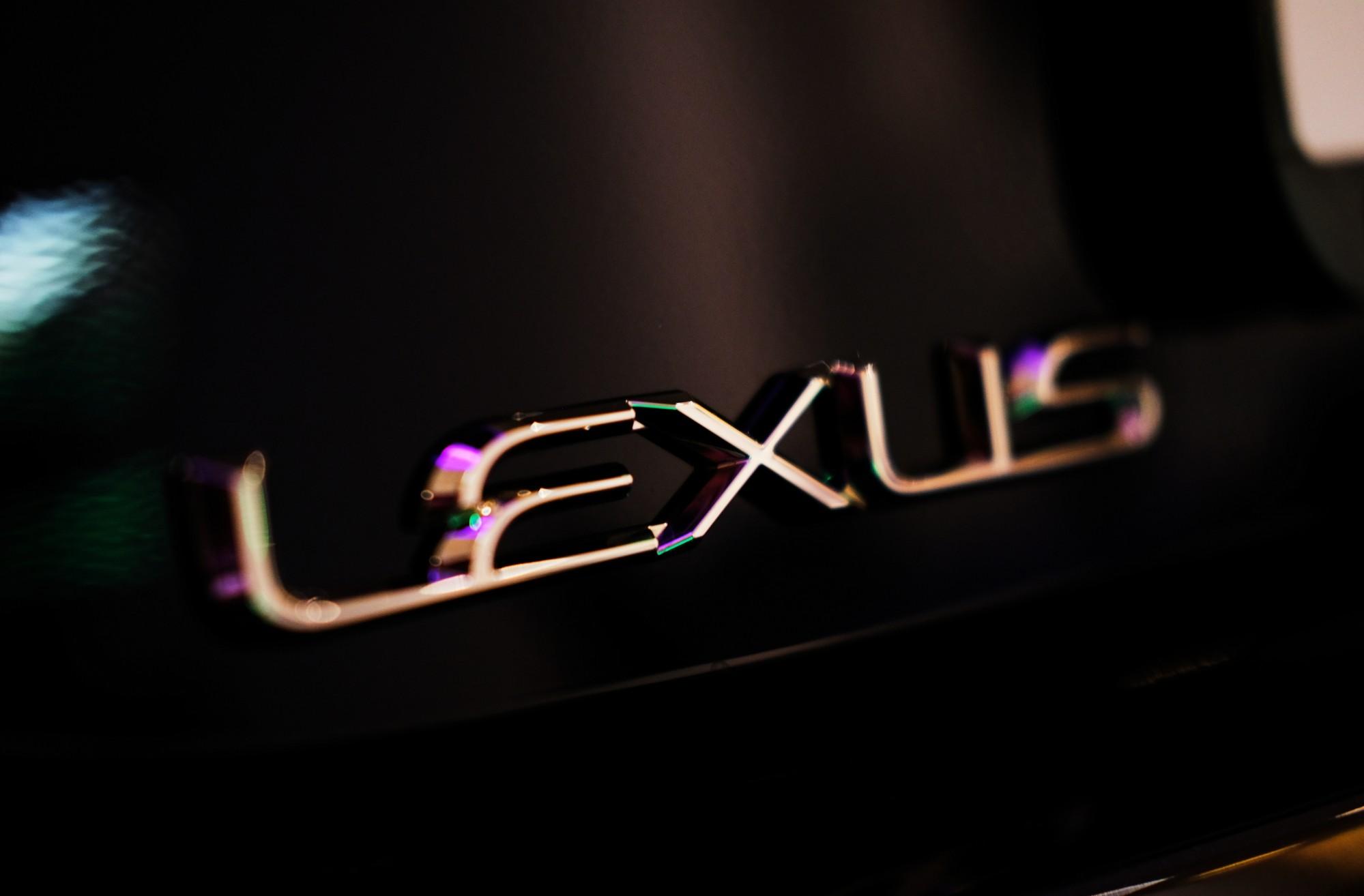 The Lexus logo on the side of a car.