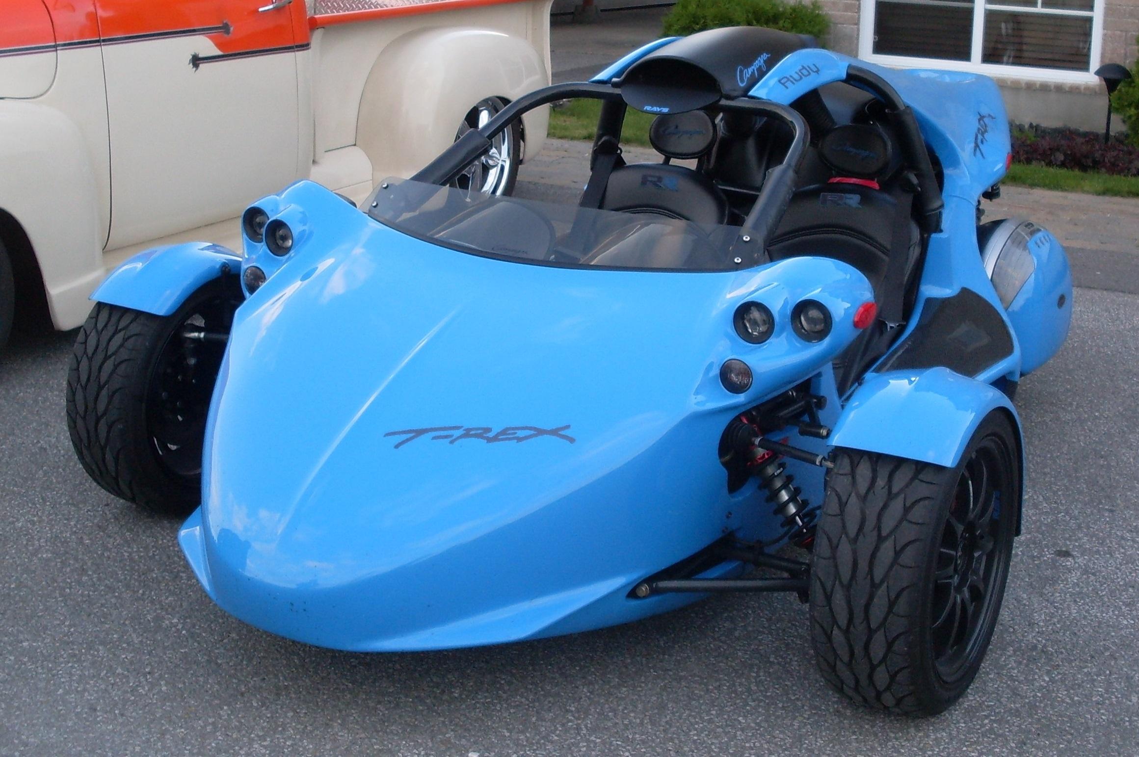 Front view of blue Campagna T-Rex parked in a lot