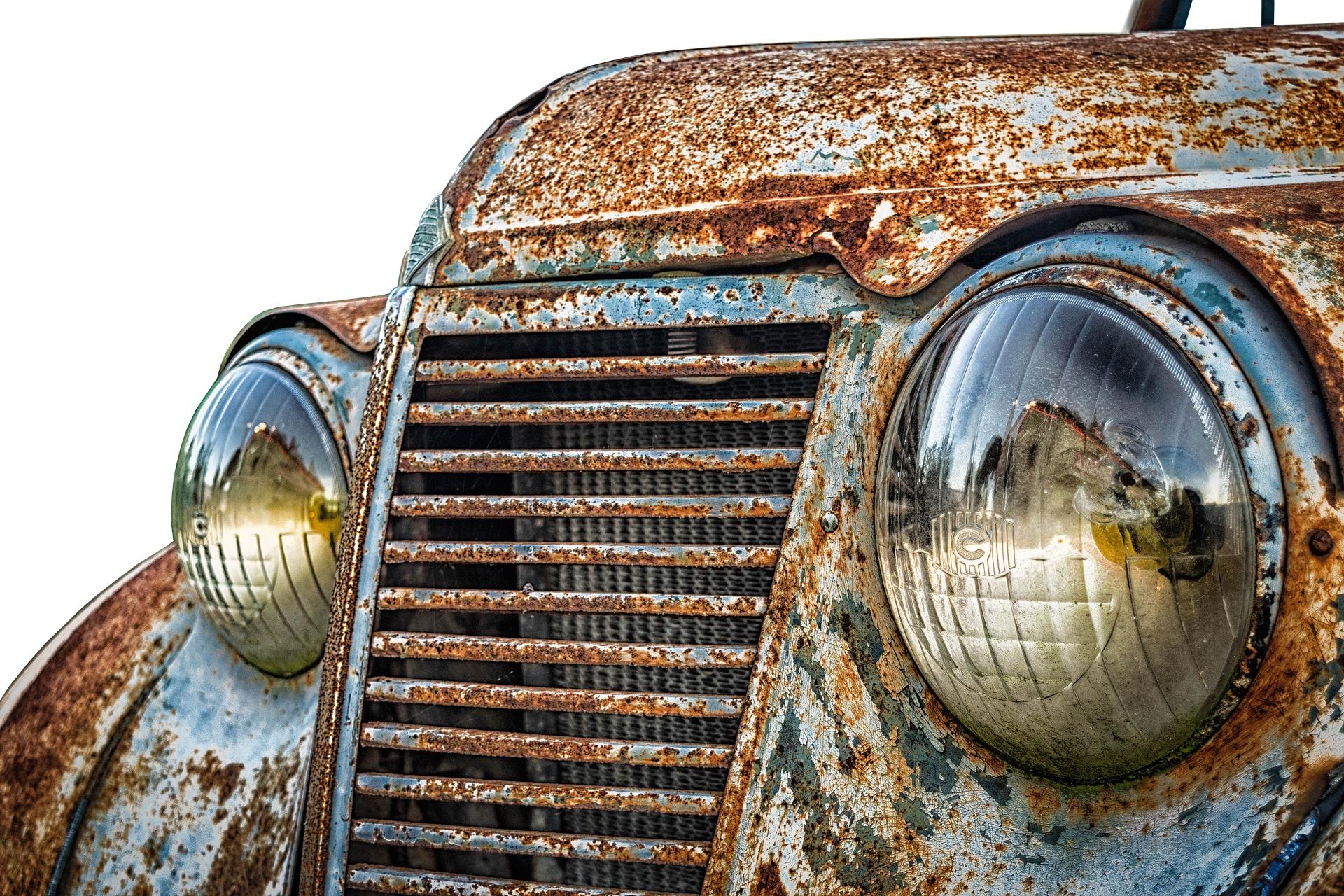 closeup of the front of a rusty car 