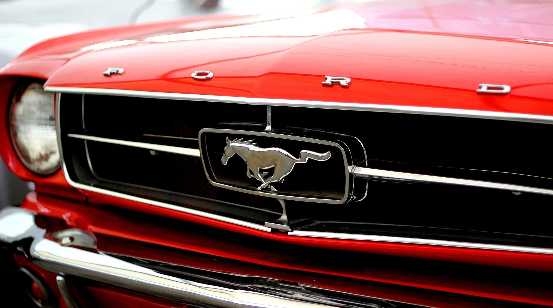 front of a red Ford Mustang