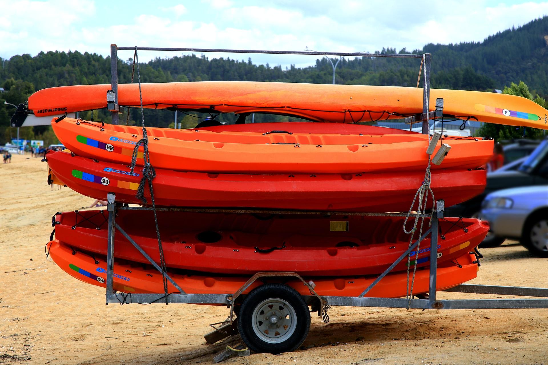 A trailer full of kayaks waiting to be towed.