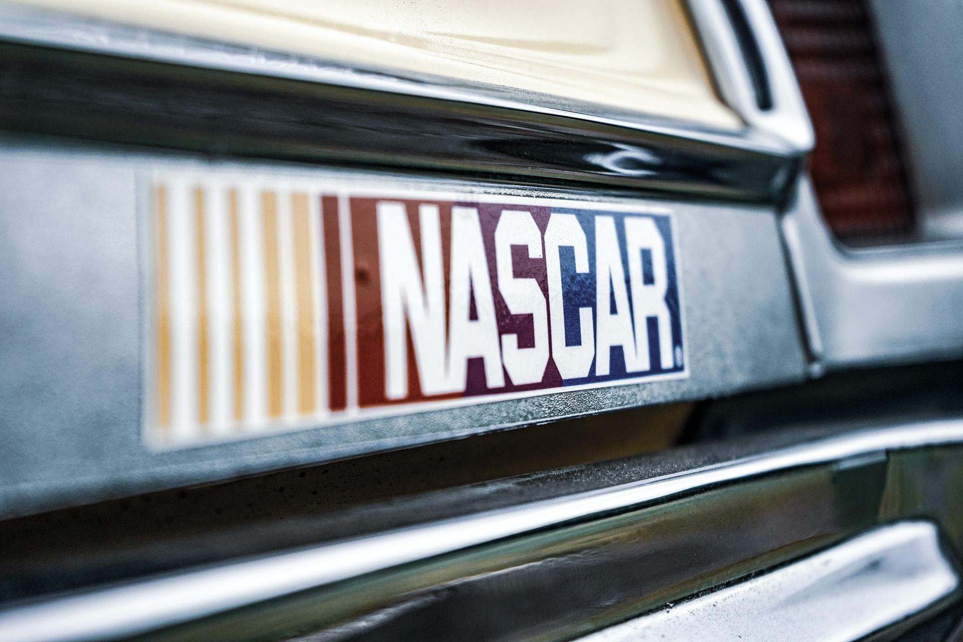 A zoomed-in photo of a NASCAR sticker on the bumper of a car.
