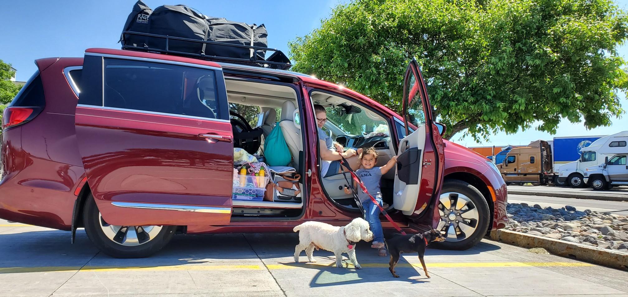 A family getting out of a minivan.