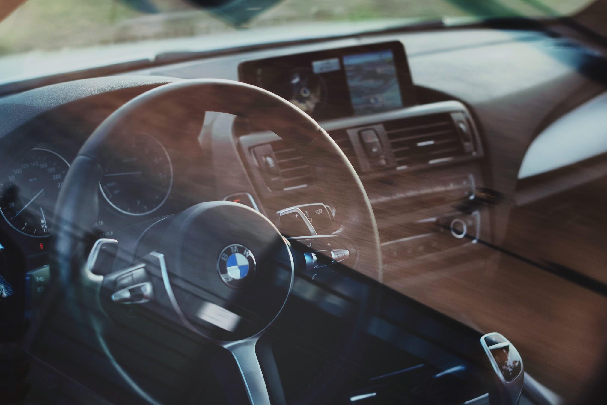 A black leather interior of a BMW luxury car.