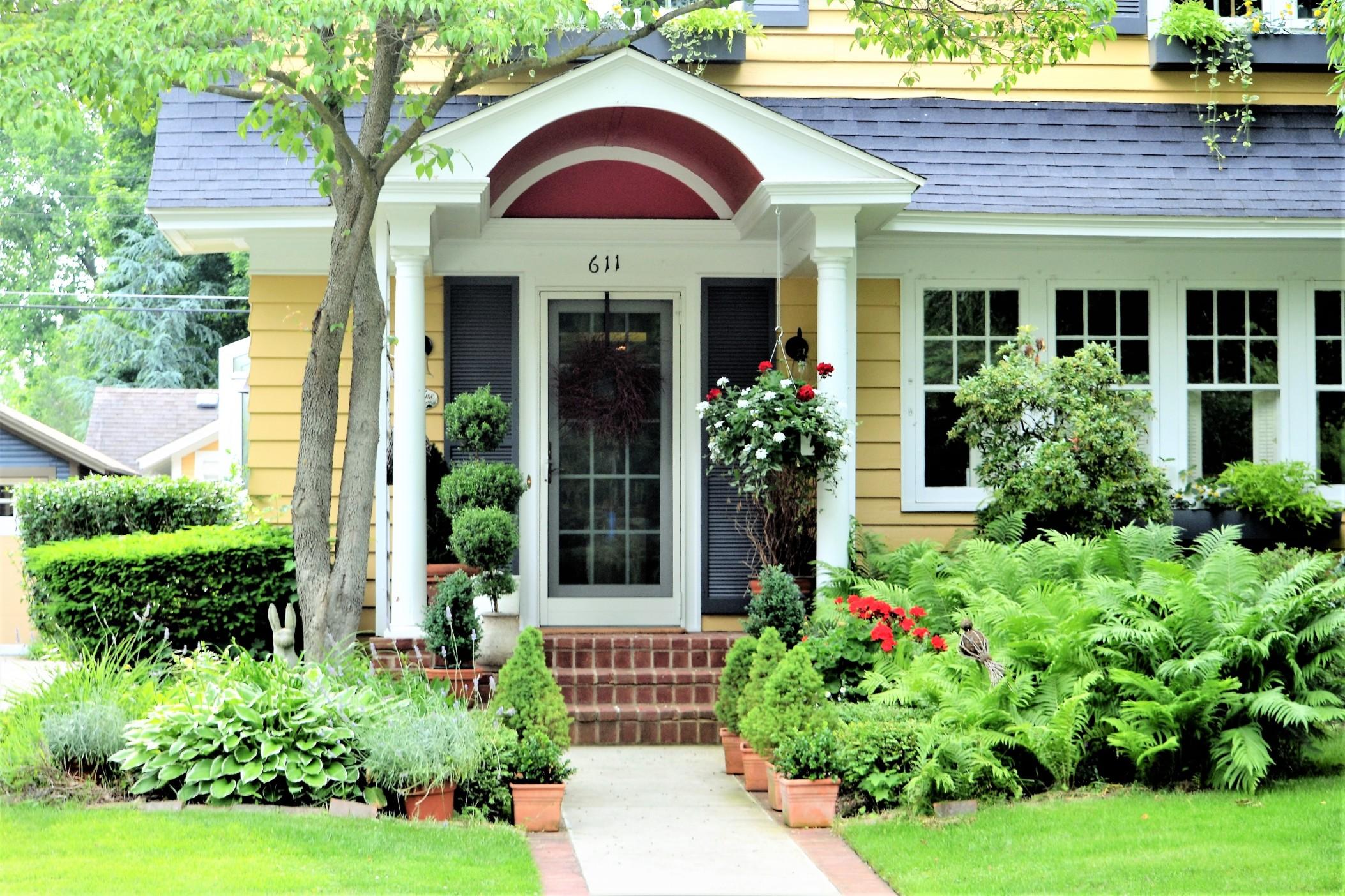 Front yard with greenery and potted plants to improve your curb appeal.
