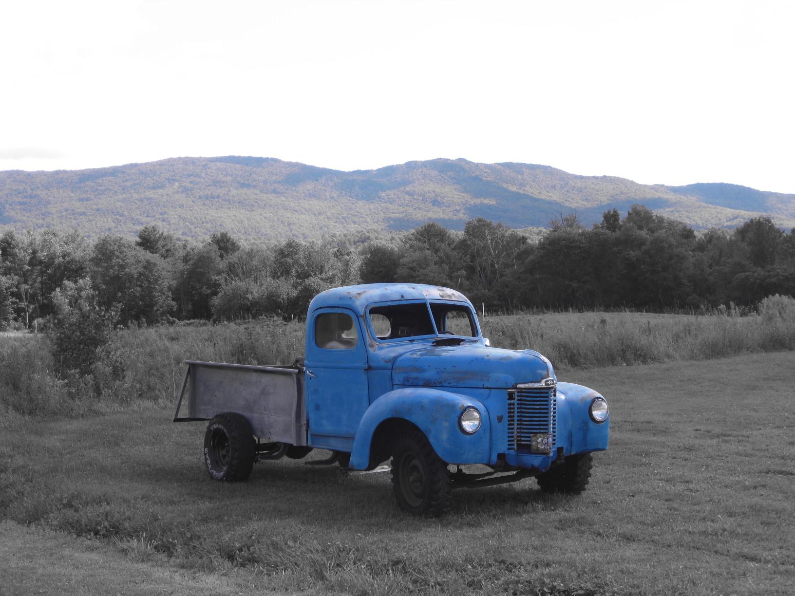 Vintage blue pickup truck parked outside of Ricker Basin in Waterbury, Vermont