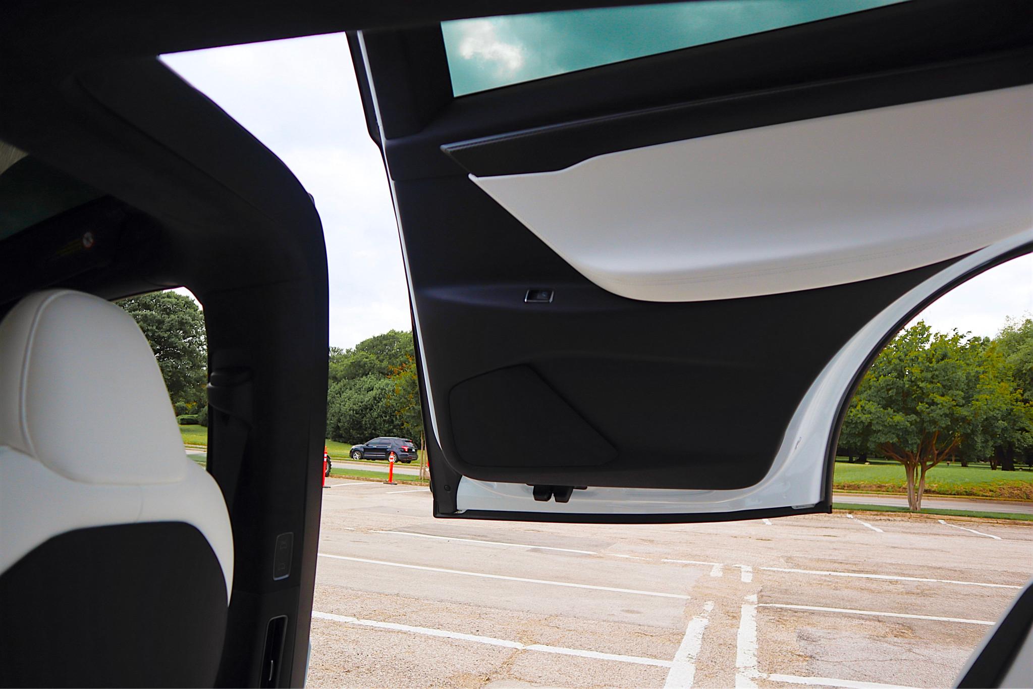 View of a white and black Tesla Model X door from the inside 