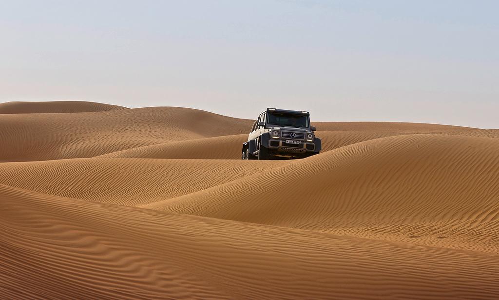 A Mercedes G63 AMG 6x6 driving in the desert