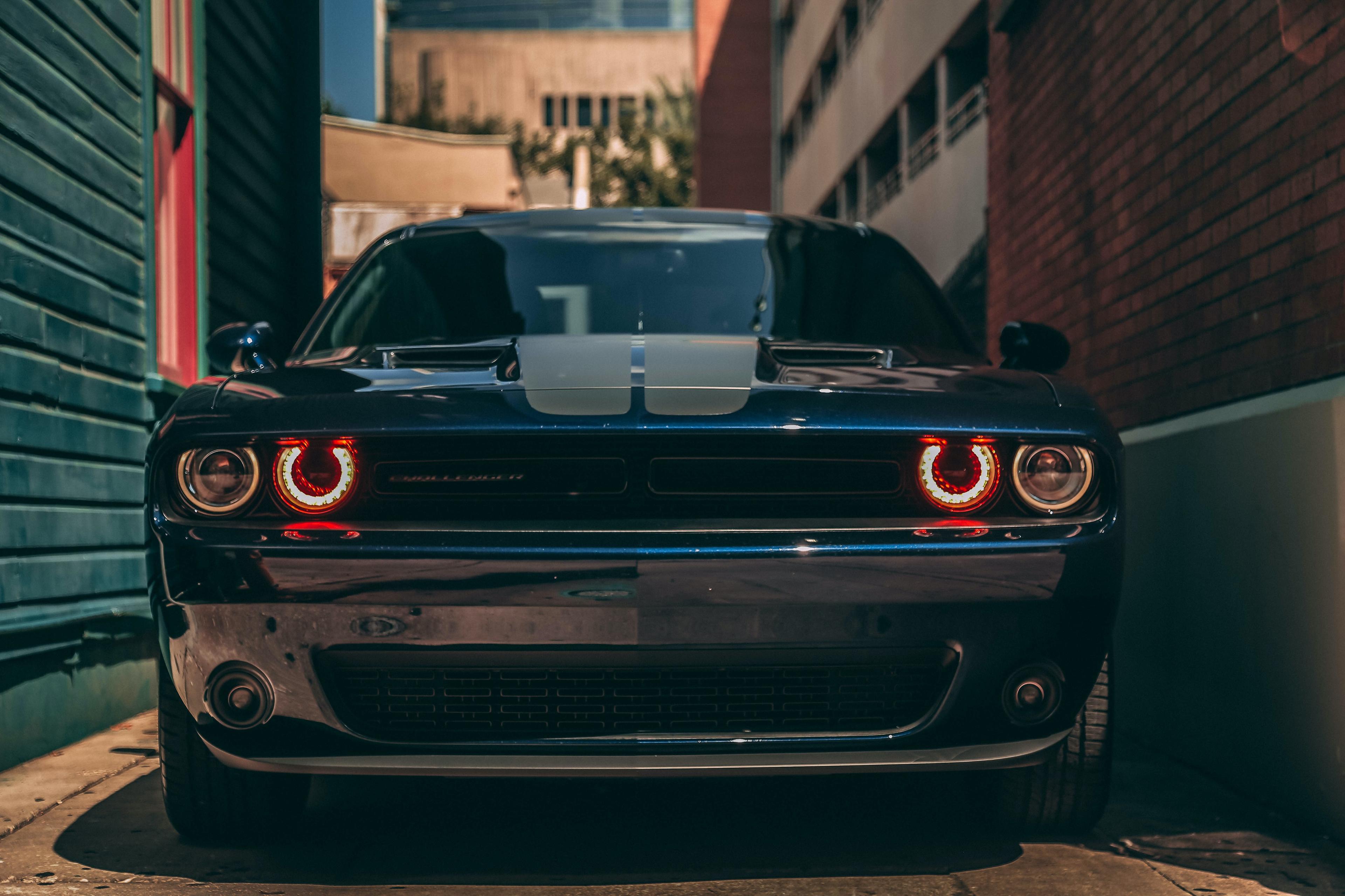 A Dodge Challenger in an alleyway. 