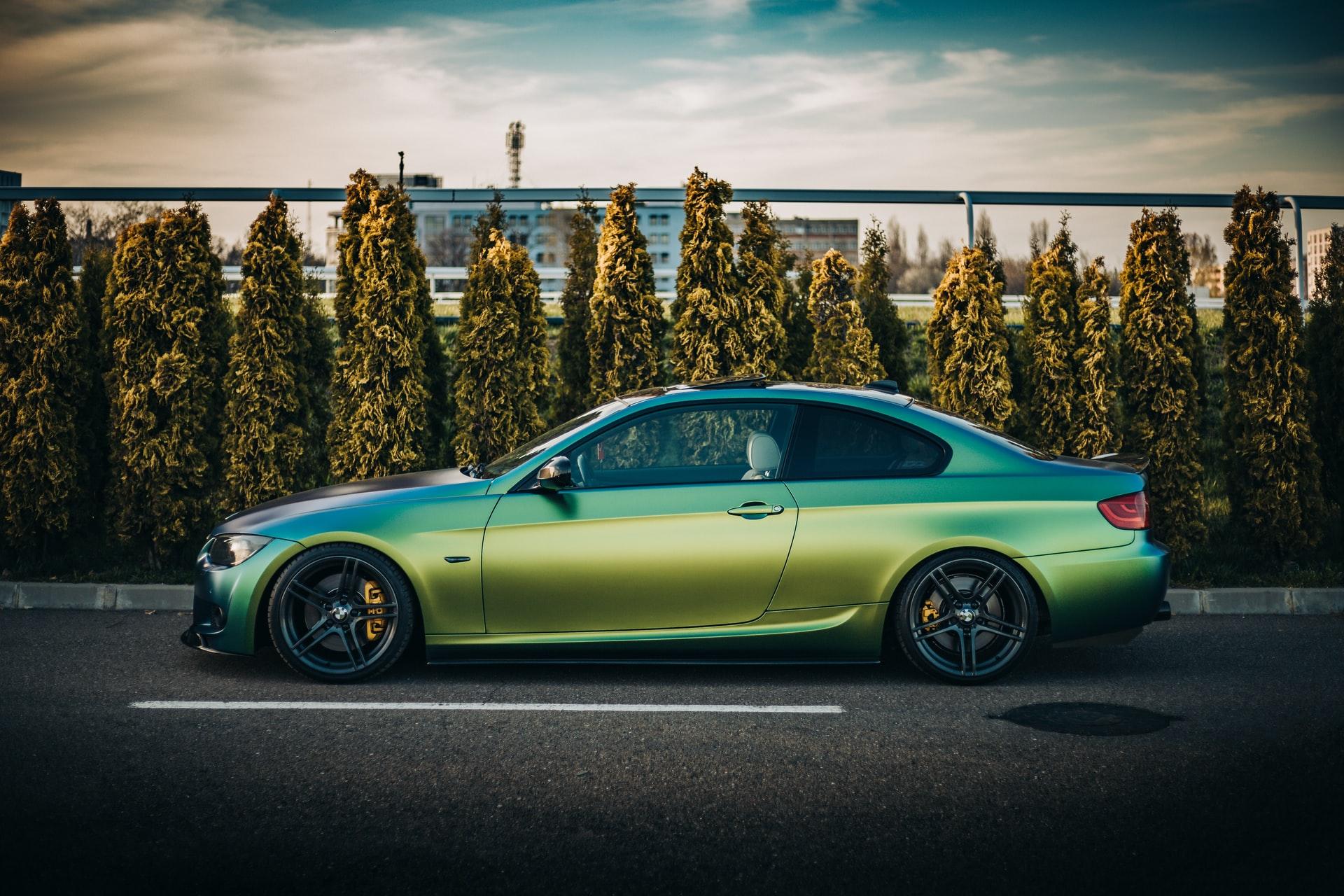 Green wrapped BMW parked in a lot