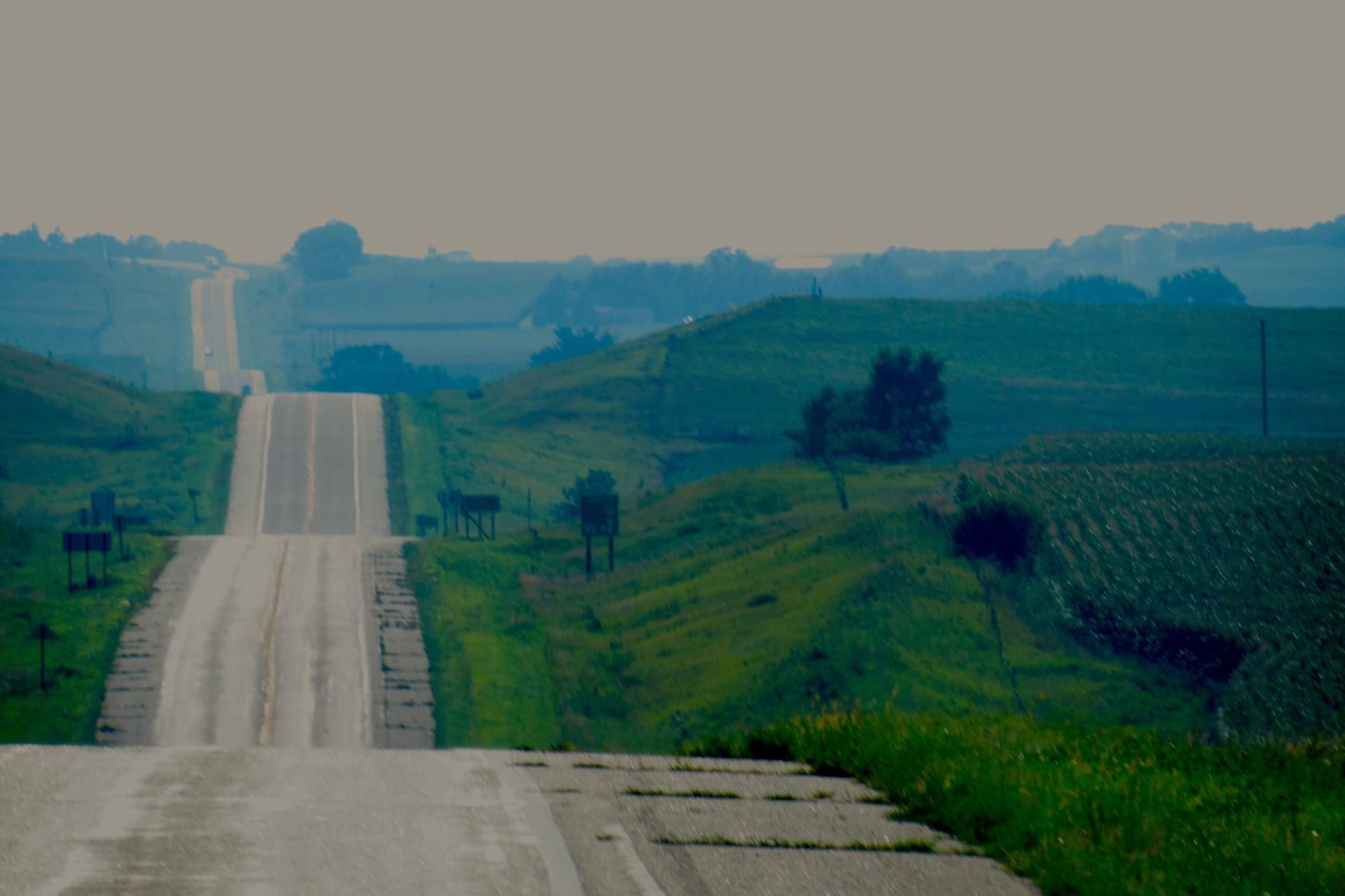 Long hilly road in Nebraska countryside