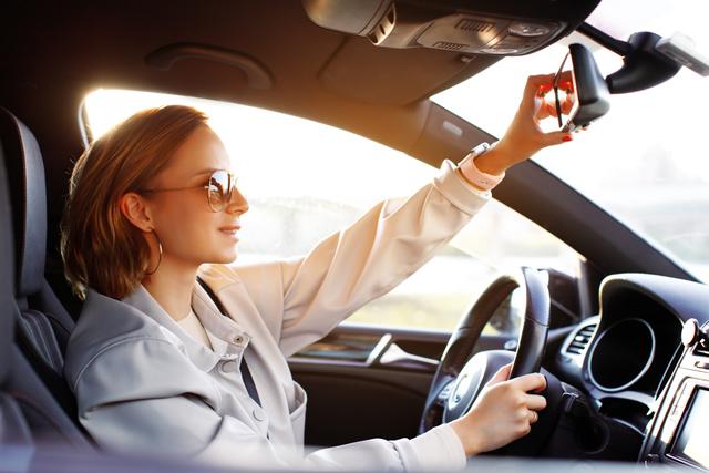 1662521898235 _woman-in-sunglasses-new-driver-sitting-in-car-riding-on-road-adjustment-of-mirror-holding-steering_t20_ynvpx9.jpg.jpeg